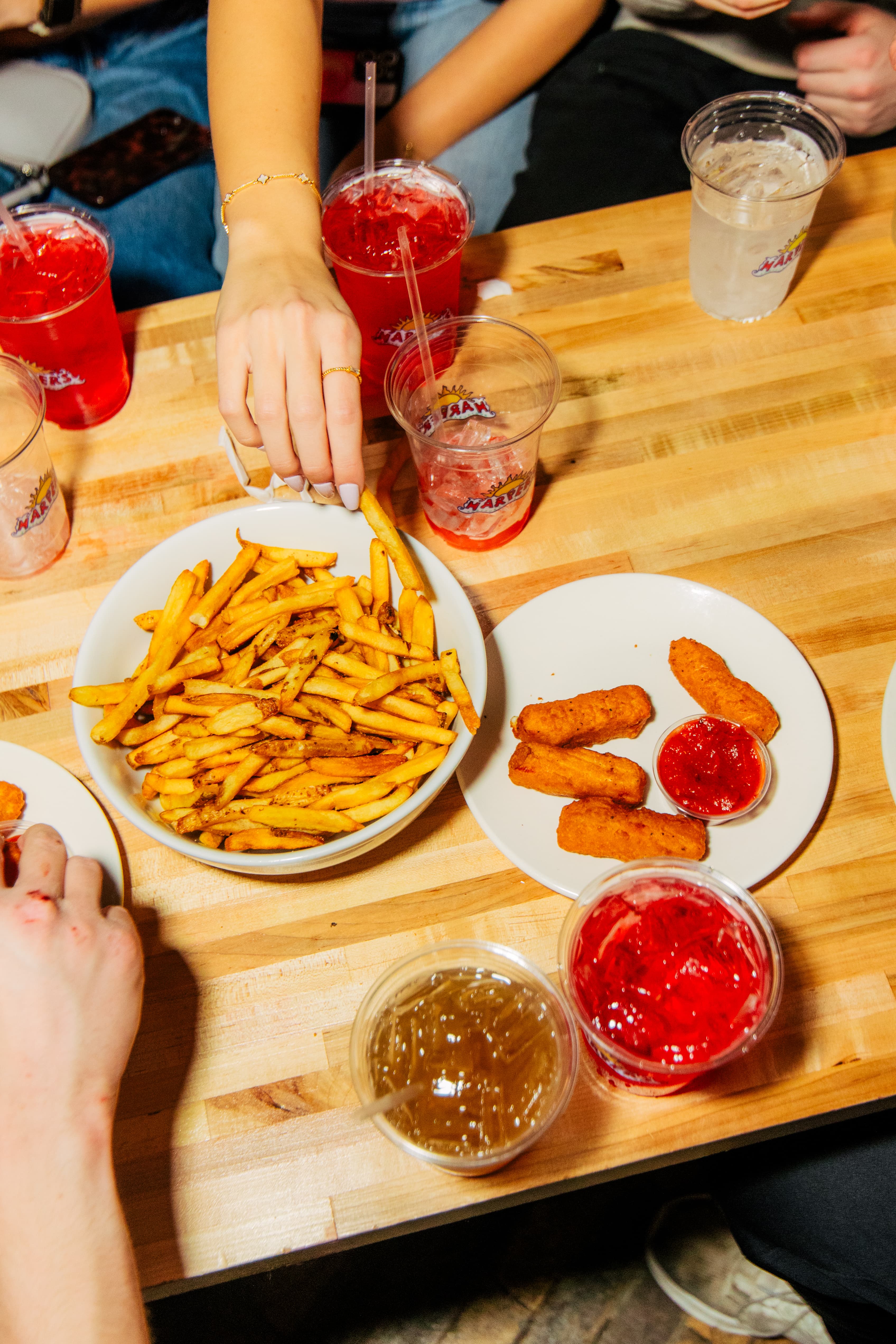 Late-night app spread at Harper's East Lansing  fries, mozzarella sticks, and signature drinks